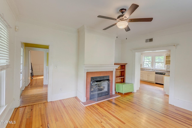 1330 Carroll Creek Rd, Gray, TN 37615 - unfurnished living room with a ceiling fan, light wood-style flooring, ornamental molding, and a fireplace with raised hearth