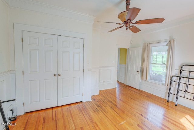 1330 Carroll Creek Rd, Gray, TN 37615 - unfurnished bedroom featuring ornamental molding, light wood-style flooring, a closet, a wainscoted wall, and a ceiling fan