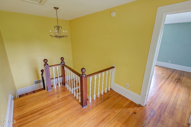 1330 Carroll Creek Rd, Gray, TN 37615 - stairway featuring hardwood / wood-style flooring and a chandelier