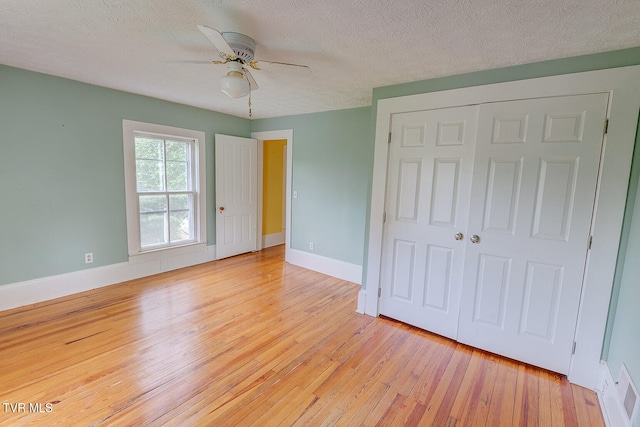 1330 Carroll Creek Rd, Gray, TN 37615 - unfurnished bedroom with light wood-type flooring, a closet, a textured ceiling, and a ceiling fan