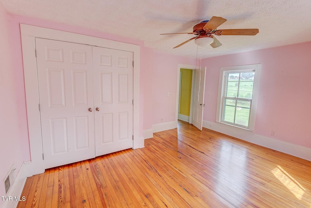 1330 Carroll Creek Rd, Gray, TN 37615 - unfurnished bedroom featuring light wood finished floors, a closet, ceiling fan, and a textured ceiling