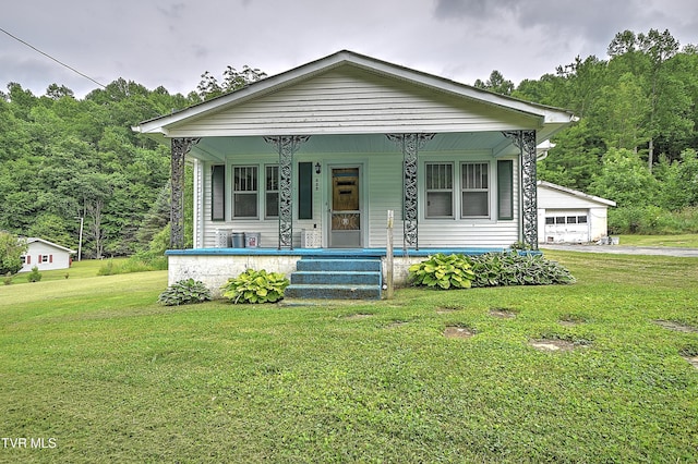 325 Cove Creek Rd, Roan Mountain, TN 37687 - view of front of home with a porch, a front yard, and a garage