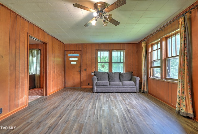 325 Cove Creek Rd, Roan Mountain, TN 37687 - living room featuring wood finished floors, wood walls, and ceiling fan