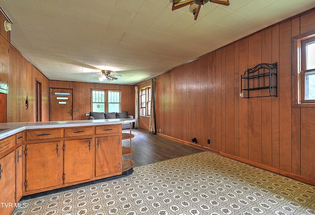 325 Cove Creek Rd, Roan Mountain, TN 37687 - kitchen with a ceiling fan, brown cabinets, wooden walls, and light countertops