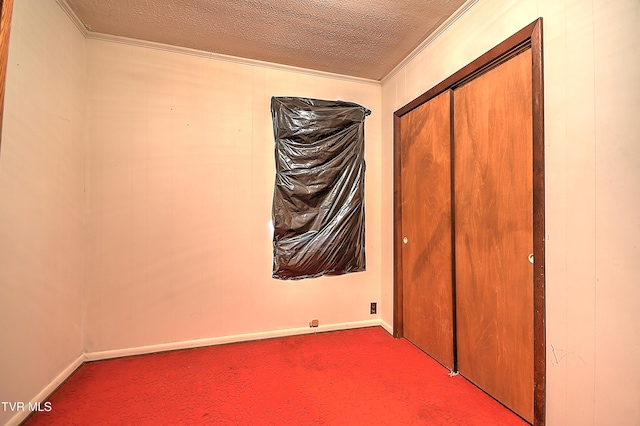 325 Cove Creek Rd, Roan Mountain, TN 37687 - unfurnished bedroom featuring ornamental molding, carpet floors, a textured ceiling, and a closet