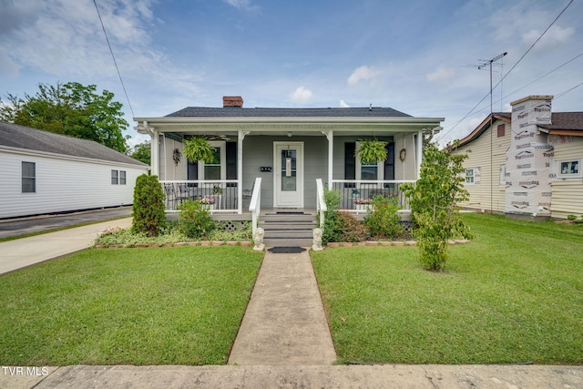 1634 Highland St, Kingsport, TN 37664 - bungalow with a porch, a chimney, and a front lawn