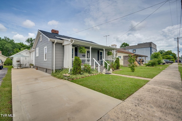 1634 Highland St, Kingsport, TN 37664 - view of front of home featuring covered porch, a chimney, concrete driveway, and a front yard