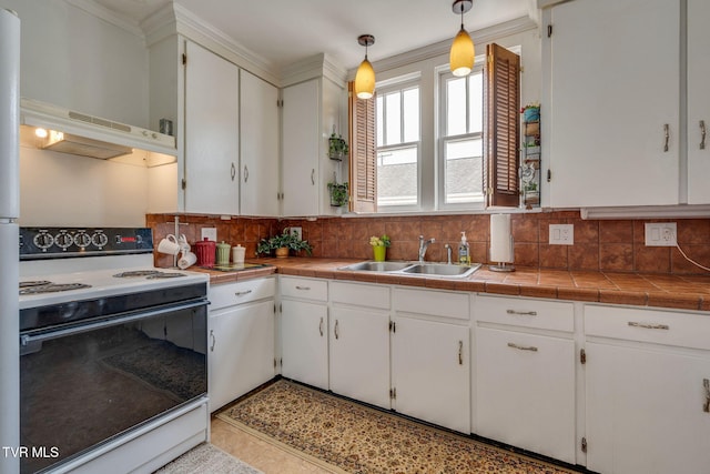 1634 Highland St, Kingsport, TN 37664 - kitchen with electric range, white cabinets, under cabinet range hood, backsplash, and crown molding