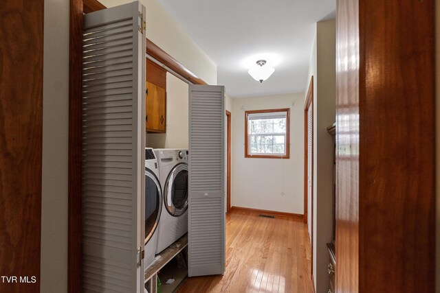 126 Poplar Hill Dr, Johnson City, TN 37604 - laundry room featuring cabinet space, light wood finished floors, and washer / clothes dryer