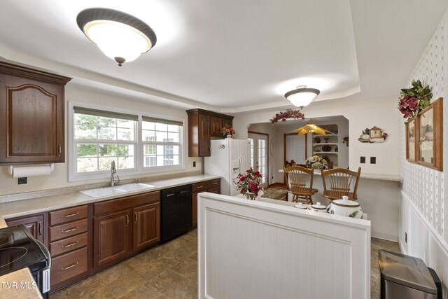 126 Poplar Hill Dr, Johnson City, TN 37604 - kitchen with black appliances, light countertops, wallpapered walls, and dark brown cabinets
