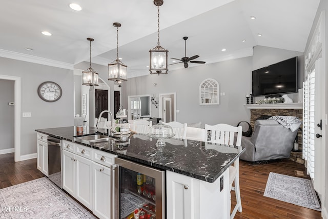 1124 Martingale Sq, Kingsport, TN 37663 - kitchen with beverage cooler, open floor plan, a ceiling fan, white cabinets, and a fireplace