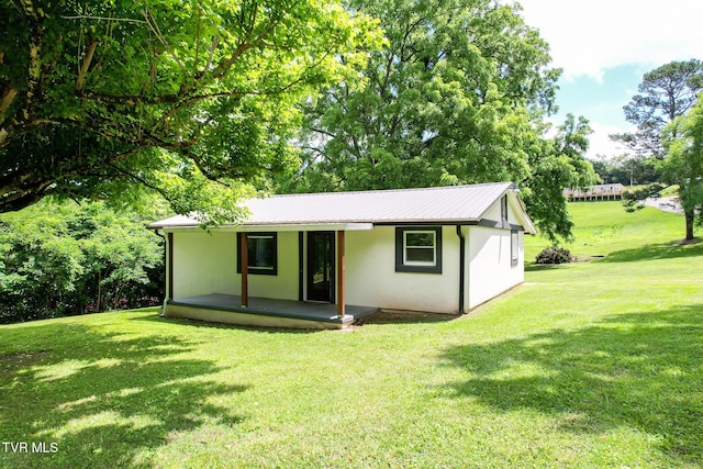 265 Hightop Rd, Midway, TN 37809 - view of front of house featuring stucco siding, a front yard, a metal roof, and a porch