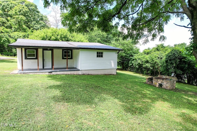 265 Hightop Rd, Midway, TN 37809 - view of front facade featuring a front yard, a metal roof, covered porch, and view of scattered trees