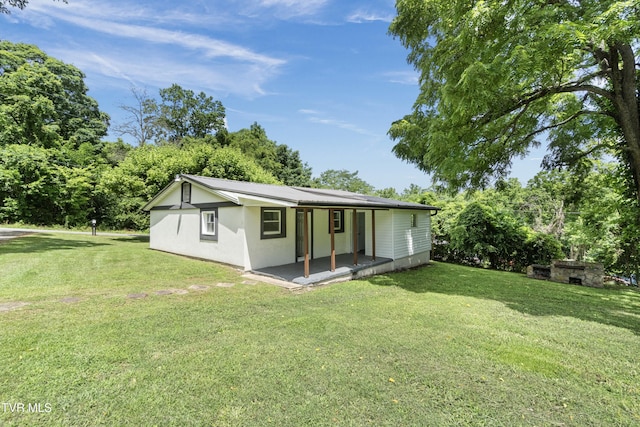 265 Hightop Rd, Midway, TN 37809 - back of property featuring a yard, stucco siding, and view of wooded area