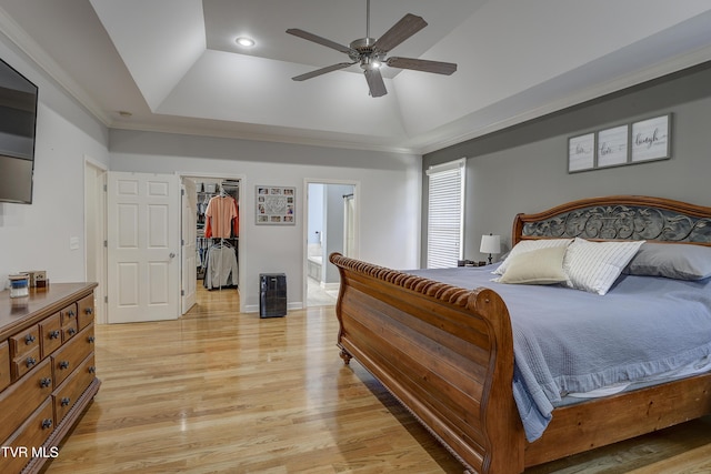 305 Emerald Chase Cir, Johnson City, TN 37615 - bedroom with a tray ceiling, a walk in closet, light wood finished floors, a closet, and a ceiling fan