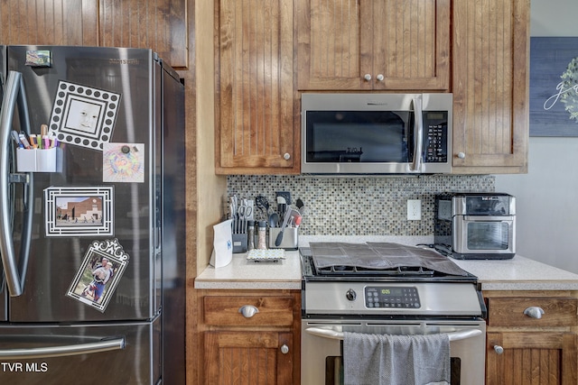 305 Emerald Chase Cir, Johnson City, TN 37615 - kitchen with appliances with stainless steel finishes, backsplash, light countertops, and brown cabinets