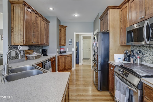 305 Emerald Chase Cir, Johnson City, TN 37615 - kitchen featuring stainless steel appliances, backsplash, light wood-style floors, light countertops, and brown cabinetry