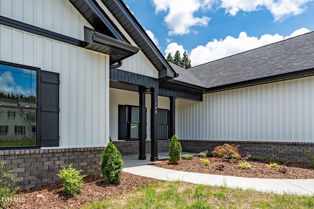 1308 Walnut Grove Rd, Jonesborough, TN 37659 - view of exterior entry with roof with shingles, a porch, board and batten siding, and brick siding