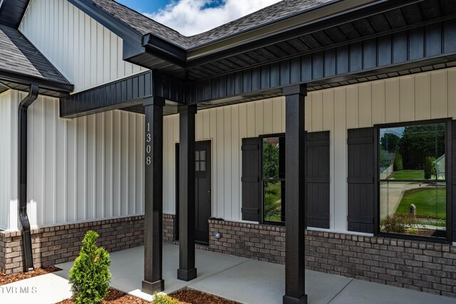 1308 Walnut Grove Rd, Jonesborough, TN 37659 - view of exterior entry featuring covered porch, brick siding, a shingled roof, and board and batten siding