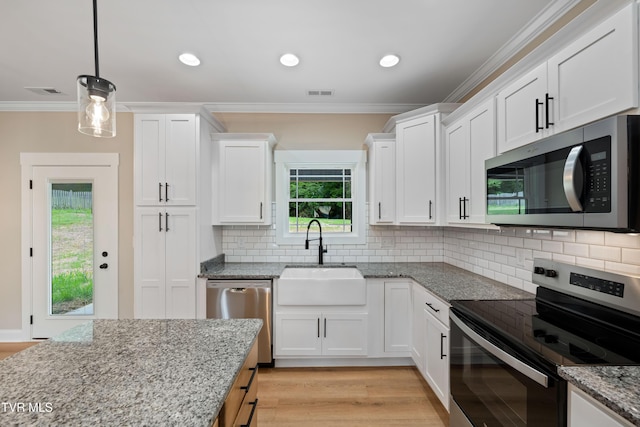 1308 Walnut Grove Rd, Jonesborough, TN 37659 - kitchen featuring appliances with stainless steel finishes, white cabinetry, ornamental molding, light stone countertops, and backsplash