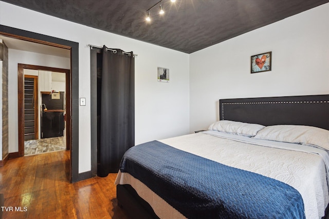26417 Old Saltworks Rd, Abingdon, VA 24210 - bedroom featuring freestanding refrigerator, wood finished floors, and rail lighting