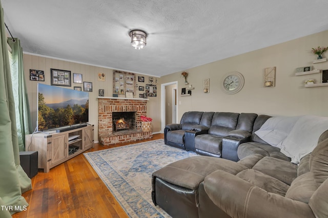 206 Cloverdale Pl, Bristol, TN 37620 - living area featuring wood finished floors, a fireplace, and a textured ceiling