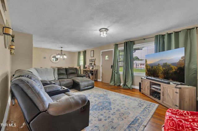 206 Cloverdale Pl, Bristol, TN 37620 - living room with a chandelier, wood finished floors, and a textured ceiling