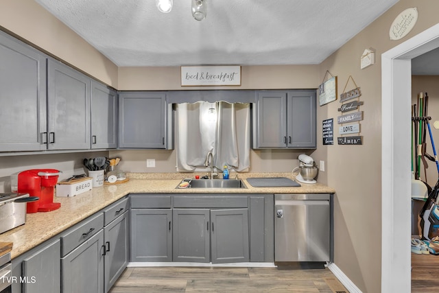 206 Cloverdale Pl, Bristol, TN 37620 - kitchen with dishwasher, gray cabinetry, light wood-type flooring, light countertops, and a textured ceiling