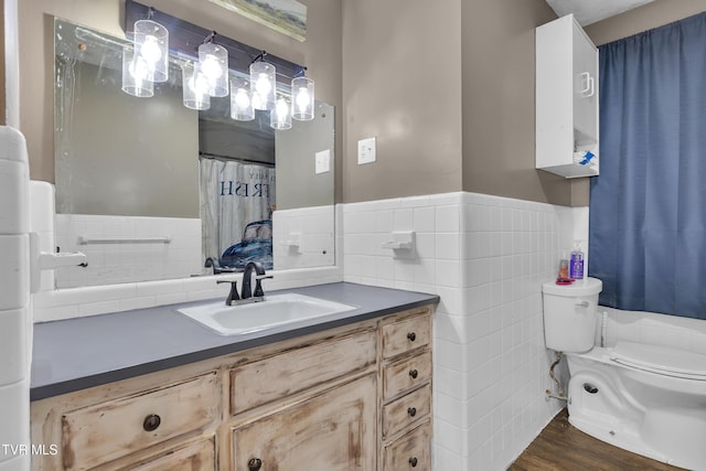 206 Cloverdale Pl, Bristol, TN 37620 - bathroom featuring tile walls, vanity, wood finished floors, and wainscoting