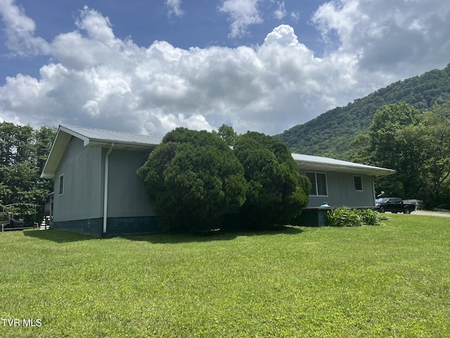 3911 Tate Springs Rd, Big Stone Gap, VA 24219 - view of home's exterior with a mountain view, a lawn, and a metal roof