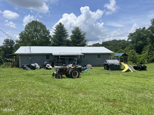 3911 Tate Springs Rd, Big Stone Gap, VA 24219 - rear view of property featuring a playground, a yard, and a metal roof