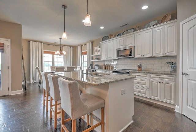 3309 Murrayfield Way, Kingsport, TN 37664 - kitchen with appliances with stainless steel finishes, a chandelier, backsplash, light stone countertops, and white cabinetry