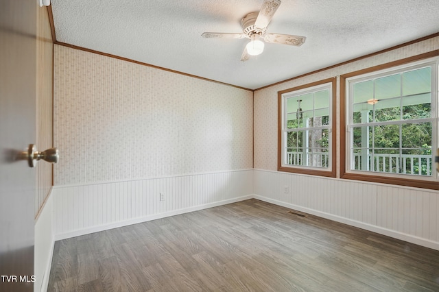 271 Anderson St, Pennington Gap, VA 24277 - unfurnished room with wood finished floors, a textured ceiling, ceiling fan, and ornamental molding