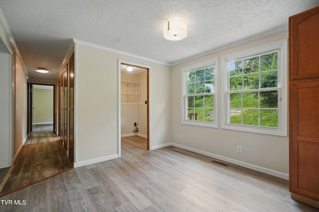271 Anderson St, Pennington Gap, VA 24277 - unfurnished bedroom with wood finished floors, ornamental molding, and a textured ceiling