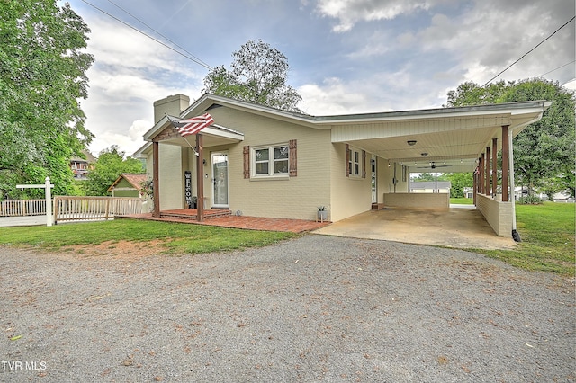 53 Grove Ave, Lebanon, VA 24266 - view of front of house featuring driveway, a carport, a chimney, and brick siding