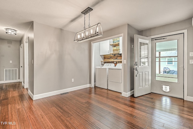 53 Grove Ave, Lebanon, VA 24266 - unfurnished dining area featuring washer and dryer, wood-type flooring, and a chandelier