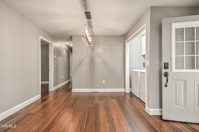 53 Grove Ave, Lebanon, VA 24266 - unfurnished dining area featuring washer and clothes dryer and dark wood-type flooring