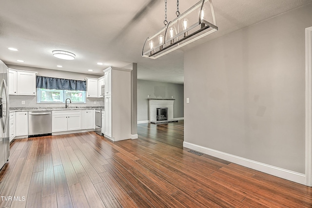 53 Grove Ave, Lebanon, VA 24266 - kitchen with appliances with stainless steel finishes, dark wood finished floors, open floor plan, decorative backsplash, and recessed lighting