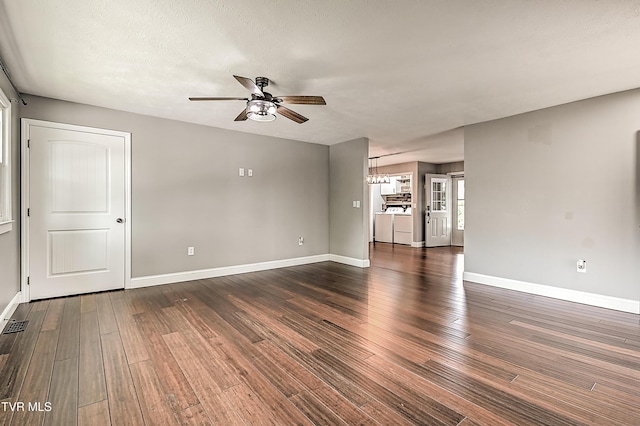 53 Grove Ave, Lebanon, VA 24266 - unfurnished living room featuring a ceiling fan, dark wood-type flooring, and a chandelier