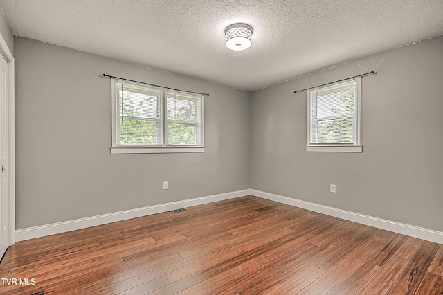 53 Grove Ave, Lebanon, VA 24266 - empty room featuring a textured ceiling and hardwood / wood-style floors