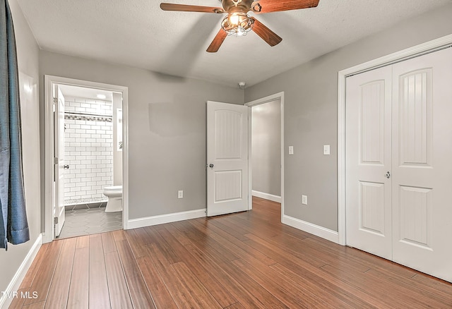 53 Grove Ave, Lebanon, VA 24266 - unfurnished bedroom featuring a closet, wood finished floors, connected bathroom, and ceiling fan