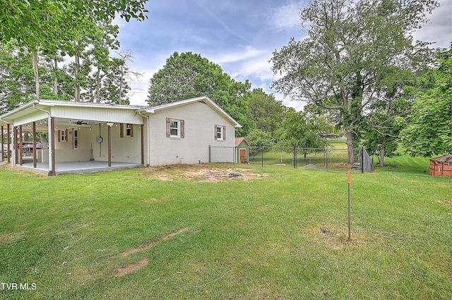 53 Grove Ave, Lebanon, VA 24266 - view of yard featuring a patio area, a storage unit, a ceiling fan, and a carport