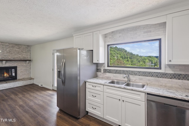 18134 Cleveland Rd, Abingdon, VA 24211 - kitchen with stainless steel appliances, a textured ceiling, dark wood finished floors, white cabinetry, and tasteful backsplash