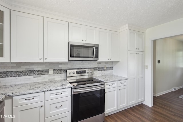 18134 Cleveland Rd, Abingdon, VA 24211 - kitchen with stainless steel appliances, dark wood finished floors, tasteful backsplash, white cabinetry, and a textured ceiling