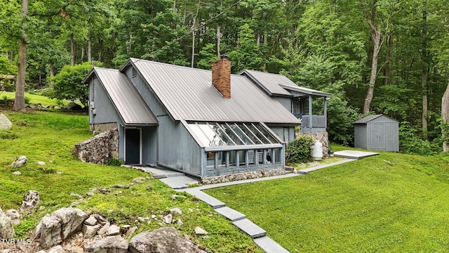 8445 Pendleton Rd, Wise, VA 24293 - back of house featuring a chimney, a storage shed, a yard, and a metal roof
