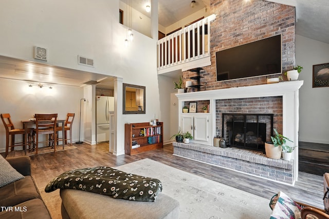 8445 Pendleton Rd, Wise, VA 24293 - living area with wood finished floors, a brick fireplace, and high vaulted ceiling