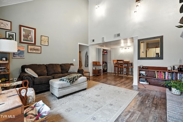 8445 Pendleton Rd, Wise, VA 24293 - living area with wood finished floors, high vaulted ceiling, and washer / dryer