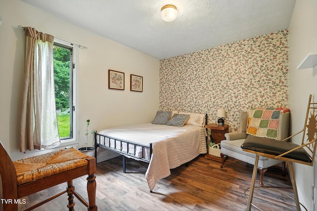 8445 Pendleton Rd, Wise, VA 24293 - bedroom featuring an accent wall, wallpapered walls, and wood finished floors