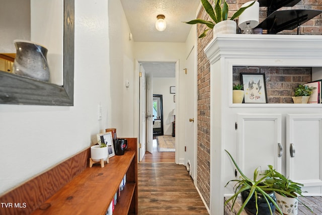 8445 Pendleton Rd, Wise, VA 24293 - corridor featuring wood finished floors, brick wall, and a textured ceiling