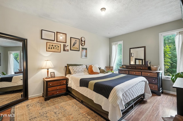 8445 Pendleton Rd, Wise, VA 24293 - bedroom featuring multiple windows, a textured ceiling, and wood finished floors